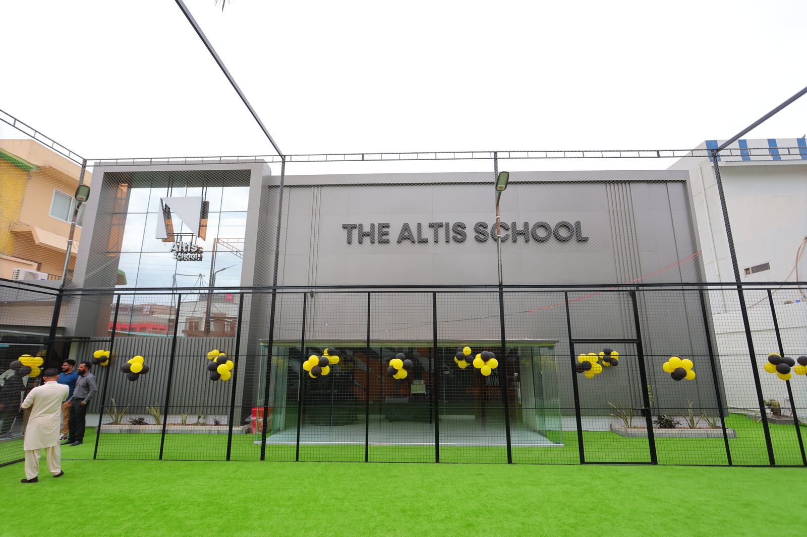 The Altis School facade with wall lettering and event decorations